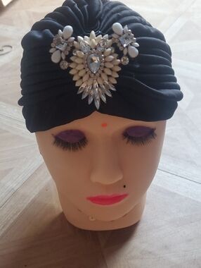 Black Brand New Head Covering With A Beautiful Embellishment.